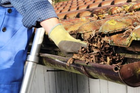 bigstock-Cleaning-A-Rain-Gutter-72788998.jpg